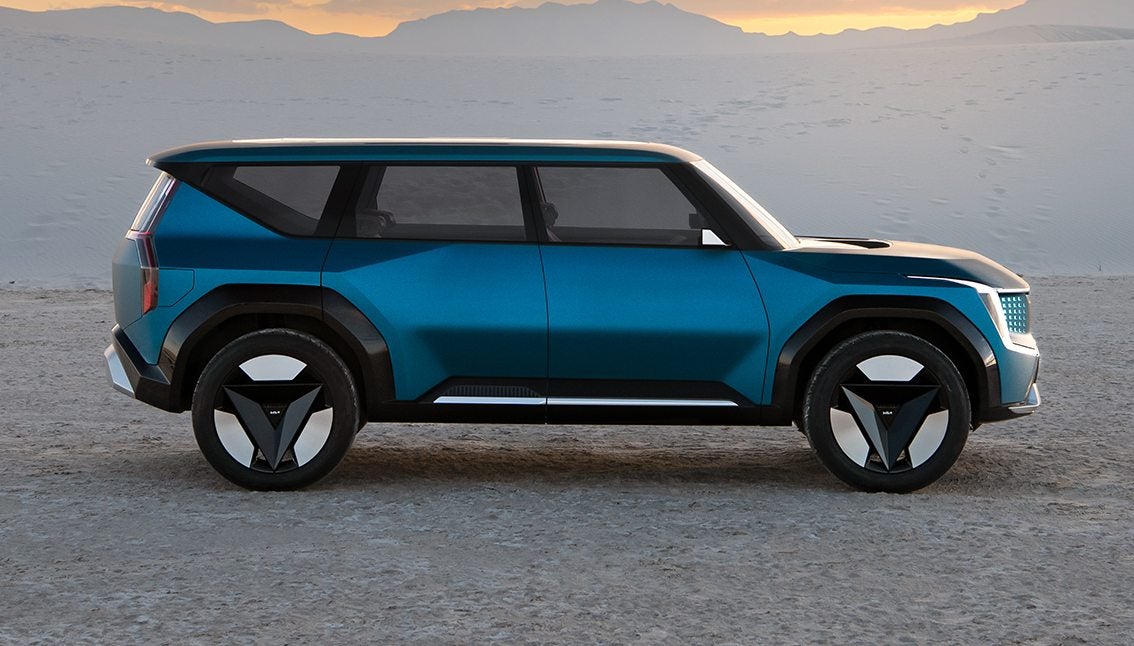 Blue Kia EV9 in profile parked in the desert