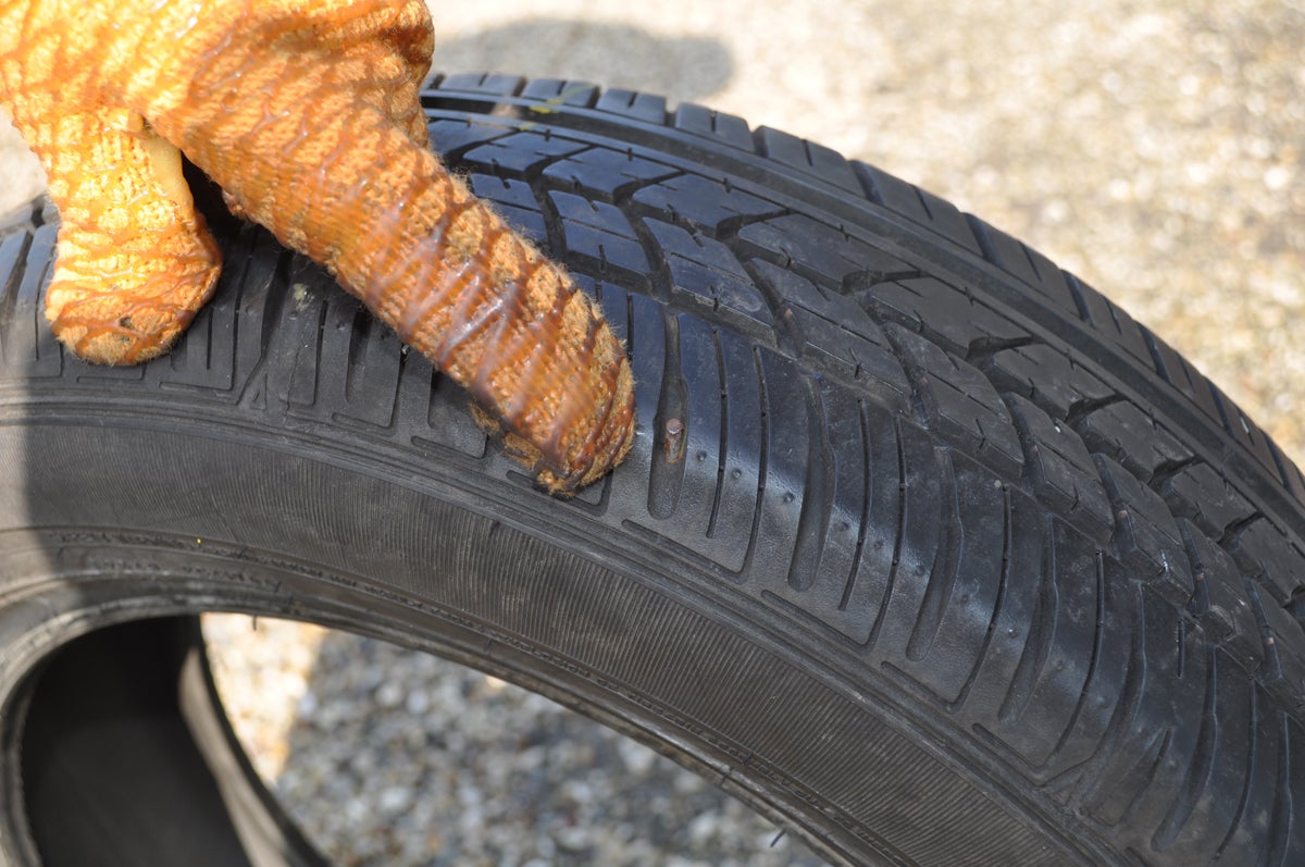 car tyre with nail damage
