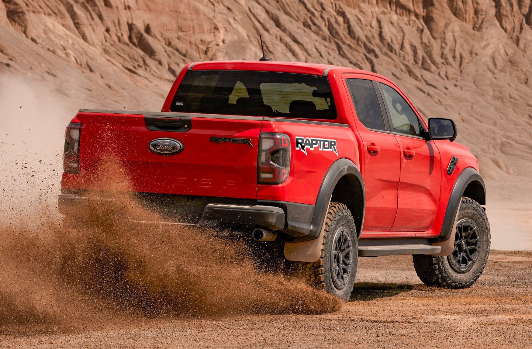 Red Ford Ranger Raptor sliding in the desert