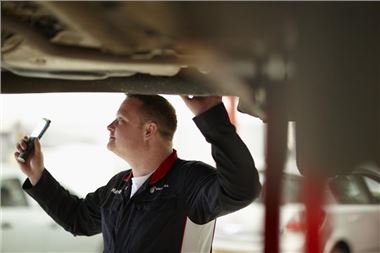 Technician working on a catalytic converter