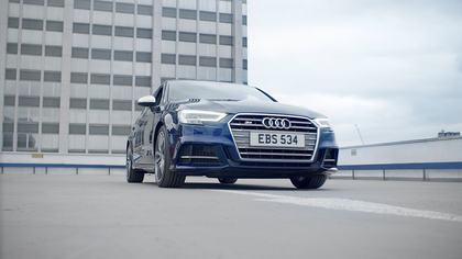 A blue Audi S3 from the front.