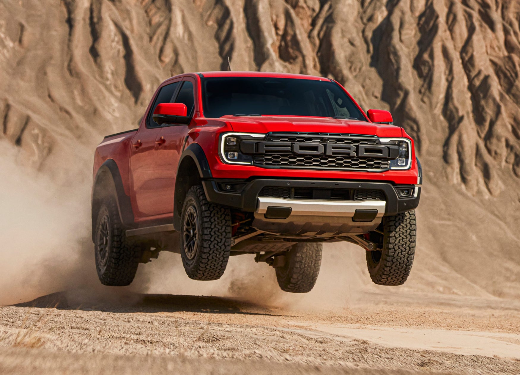 Red Ford Ranger Raptor jumping in the desert