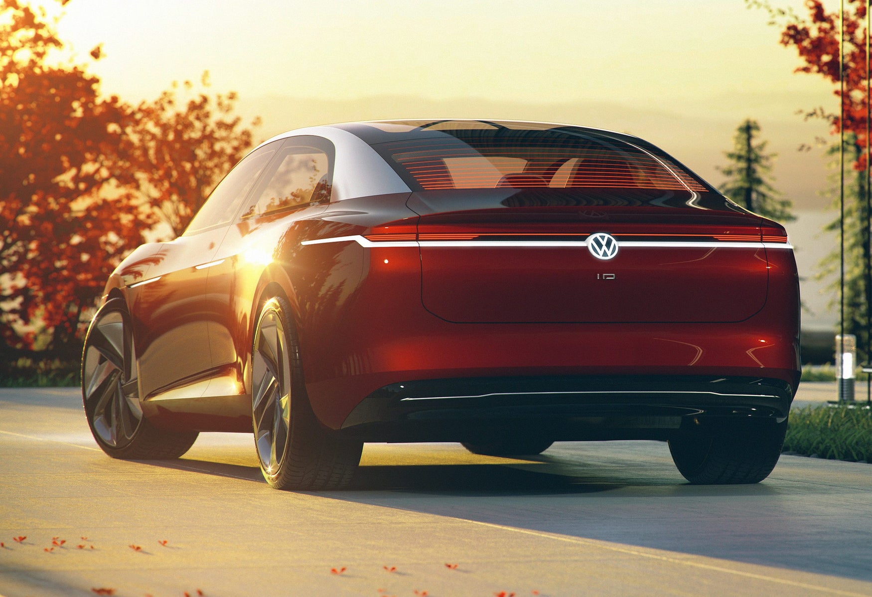 Red Volkswagen ID.Vizzion rear-three quarter view with sun set glinting off its body