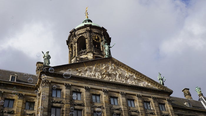 Close up of The Stadhuis Amsterdam showing statues on the roof
