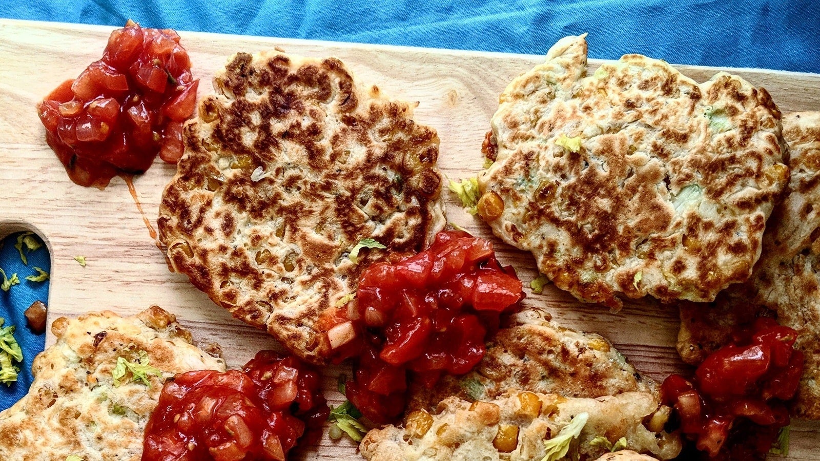 sweetcorn fritters on a wooden serving platter