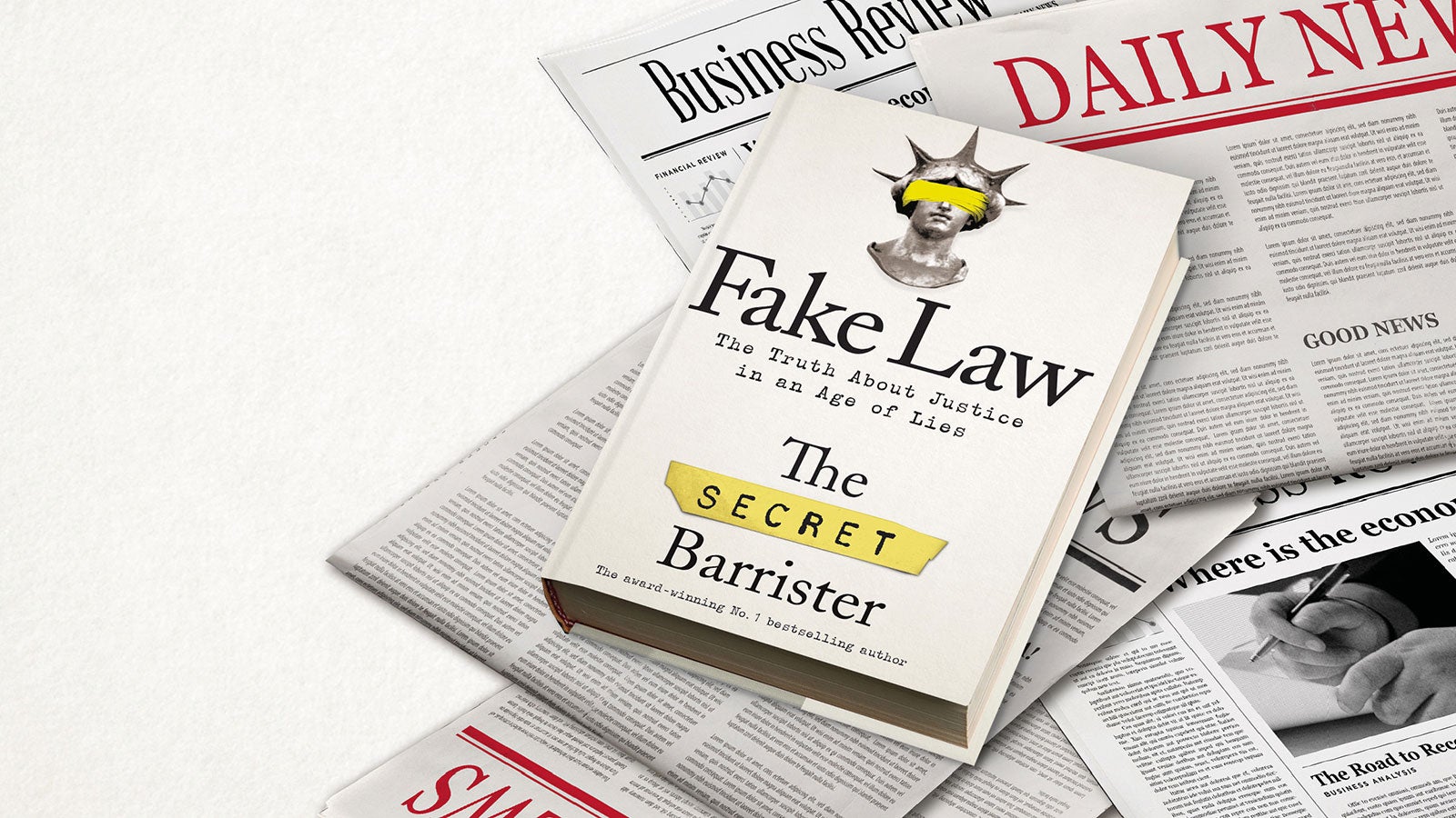Fake Law book laying on a pile of newspapers