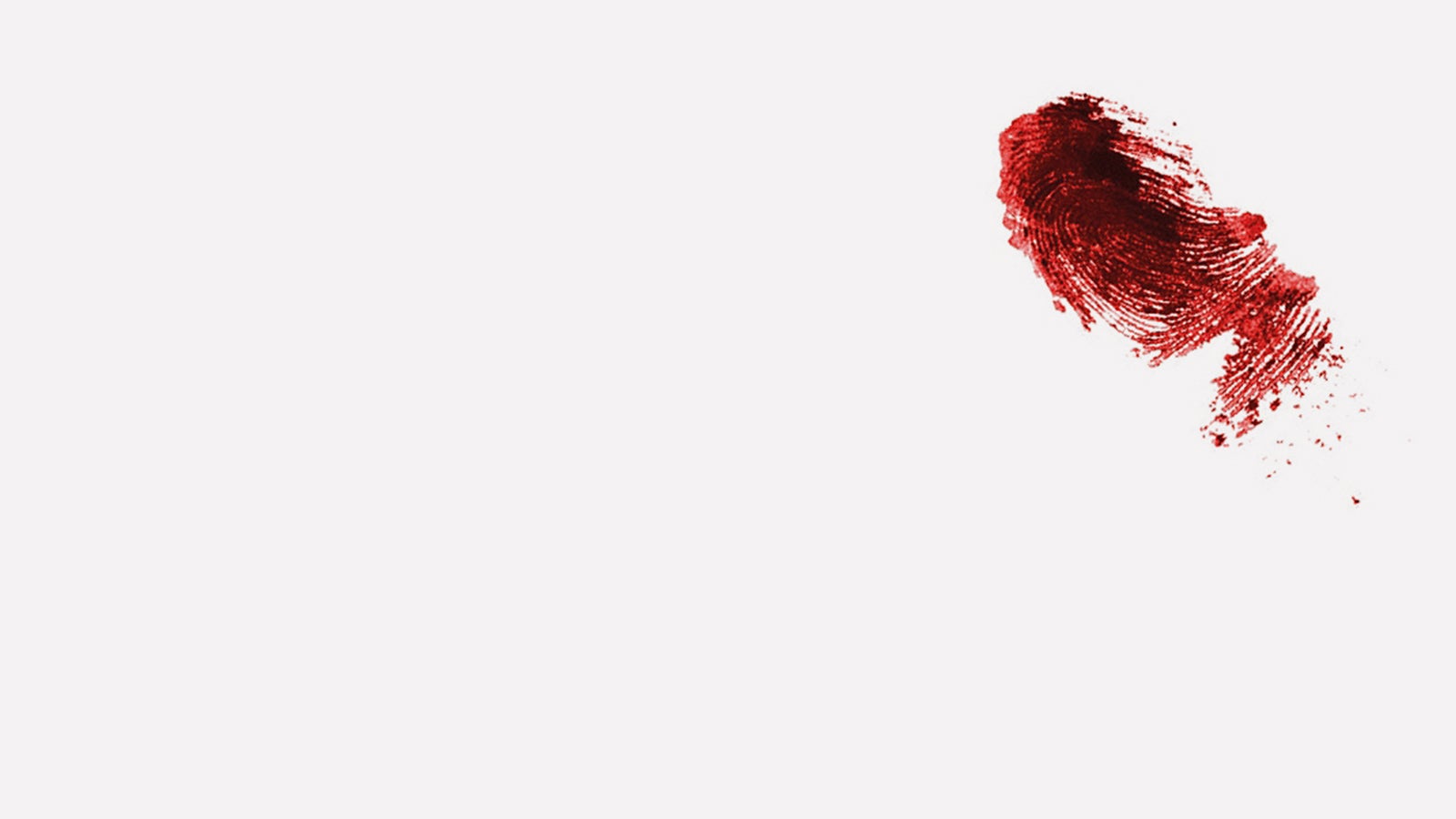A thumbprint in blood on a plain white background
