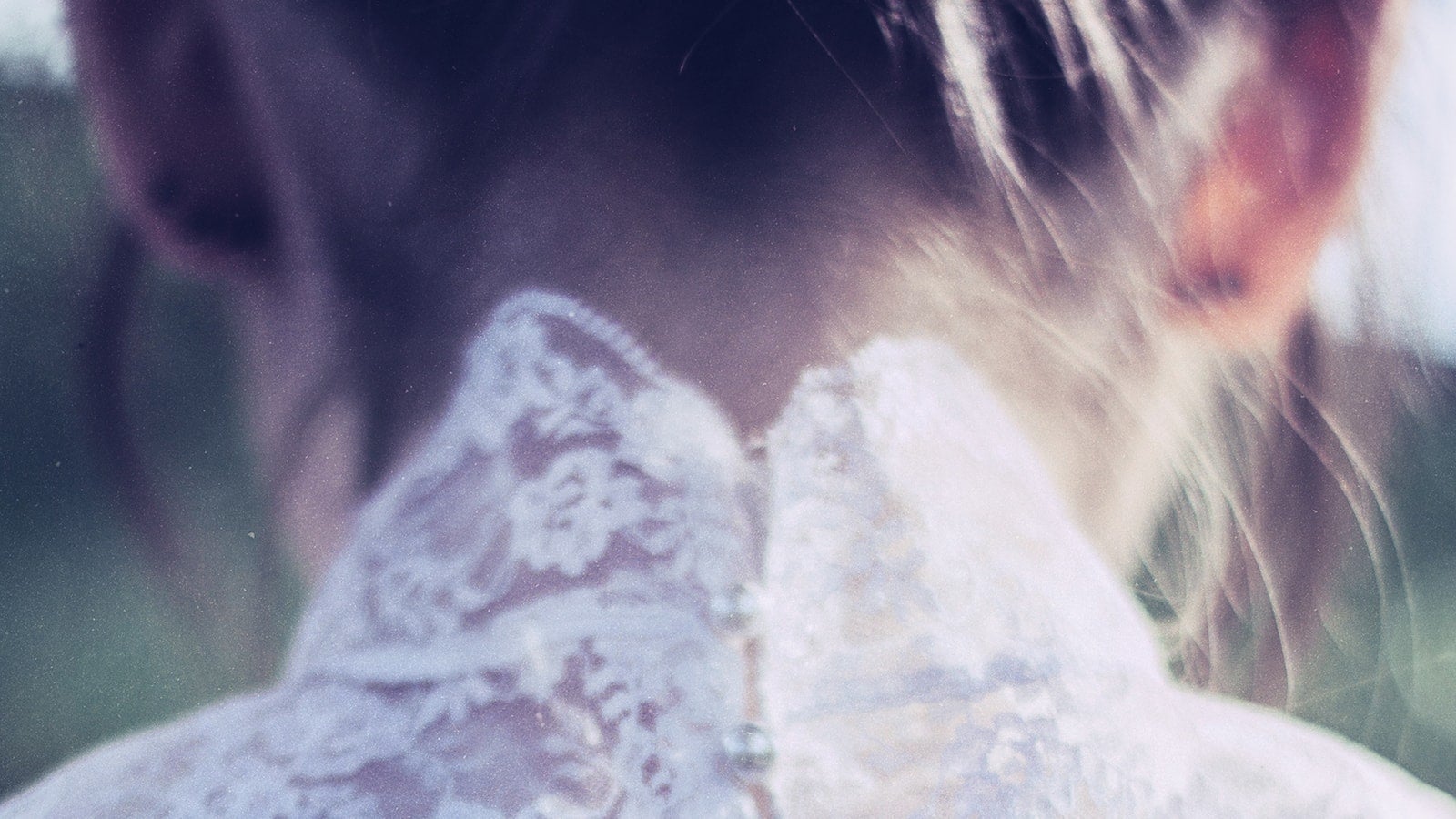 Image of the back of a woman's head in white dress, from the cover of The Woman in White