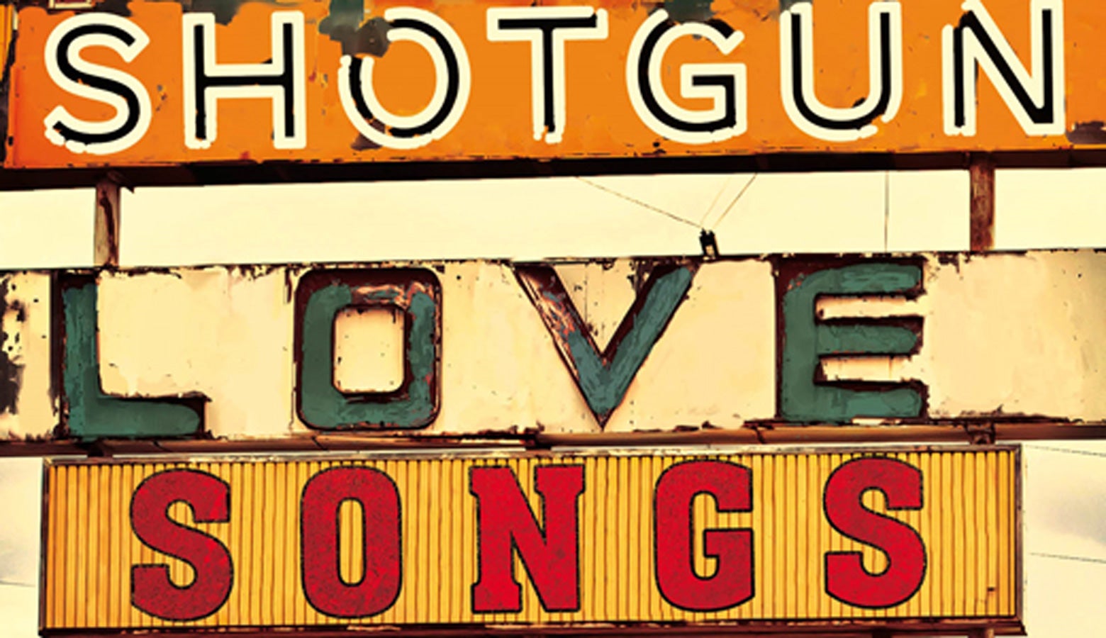 Three rusty old signs stacked on top of one another spelling out SHOTGUN LOVE SONGS
