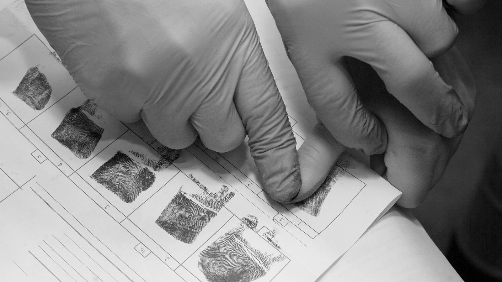 Black and white photo of ink fingerprints being taken