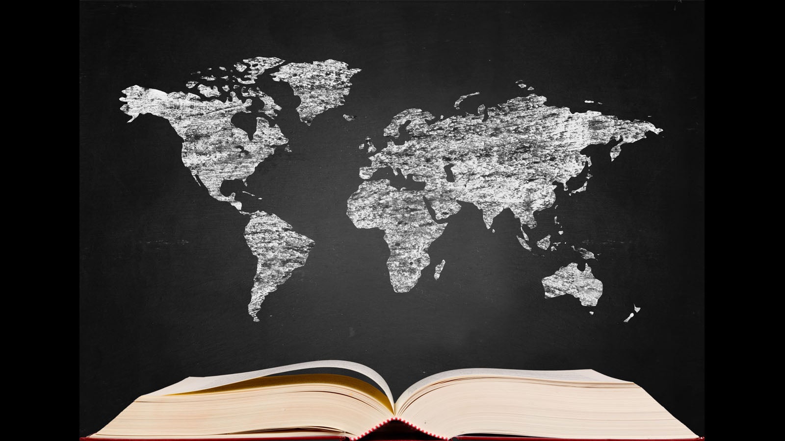 Book open in front of a world map