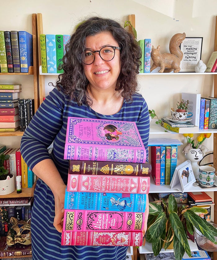 Picture of Ova Ceren holding a pile of books