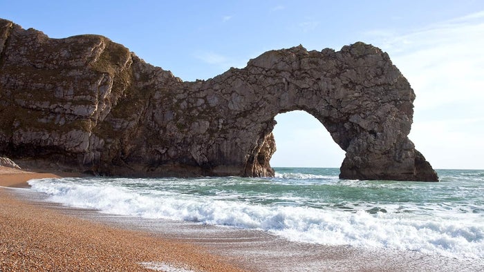 Durdle Door in Dorset with the sea beneath, on a clear summer day