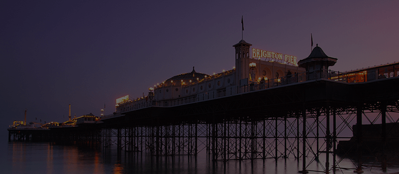 Brighton Pier lit up at dusk