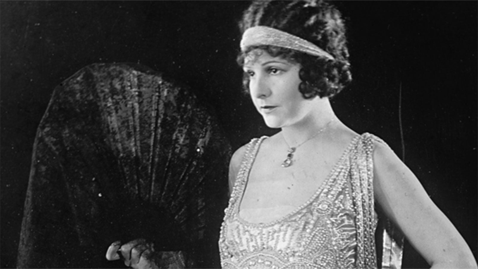 Photo of a flapper girl holding a fan