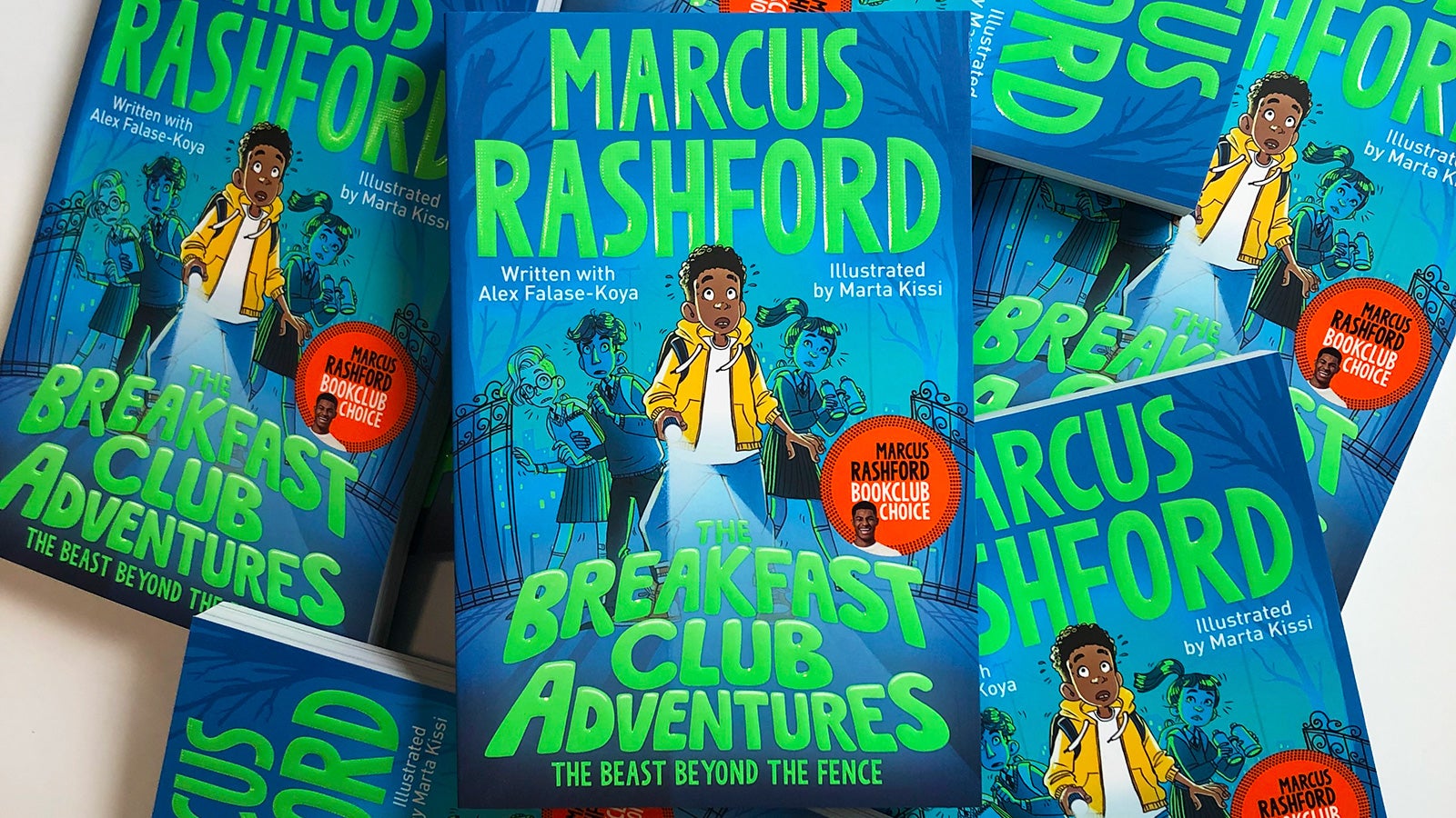 Copies of The Breakfast Club Adventures by Marcus Rashford messily spread across a table