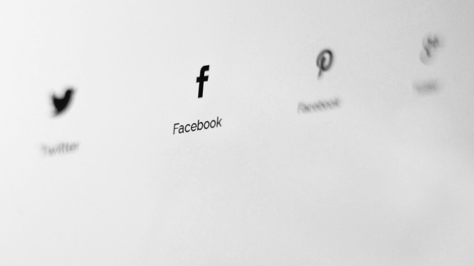White digital screen with Facebook written in black