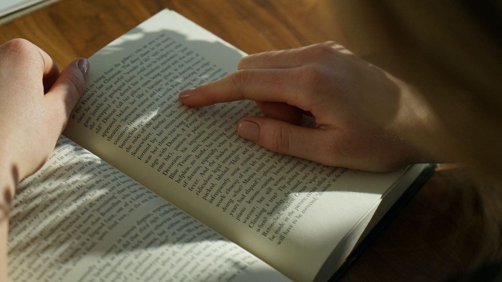 Close up of person's hands on an open book