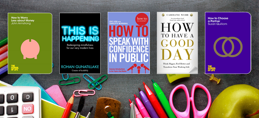 Covers of four books across a messy desk