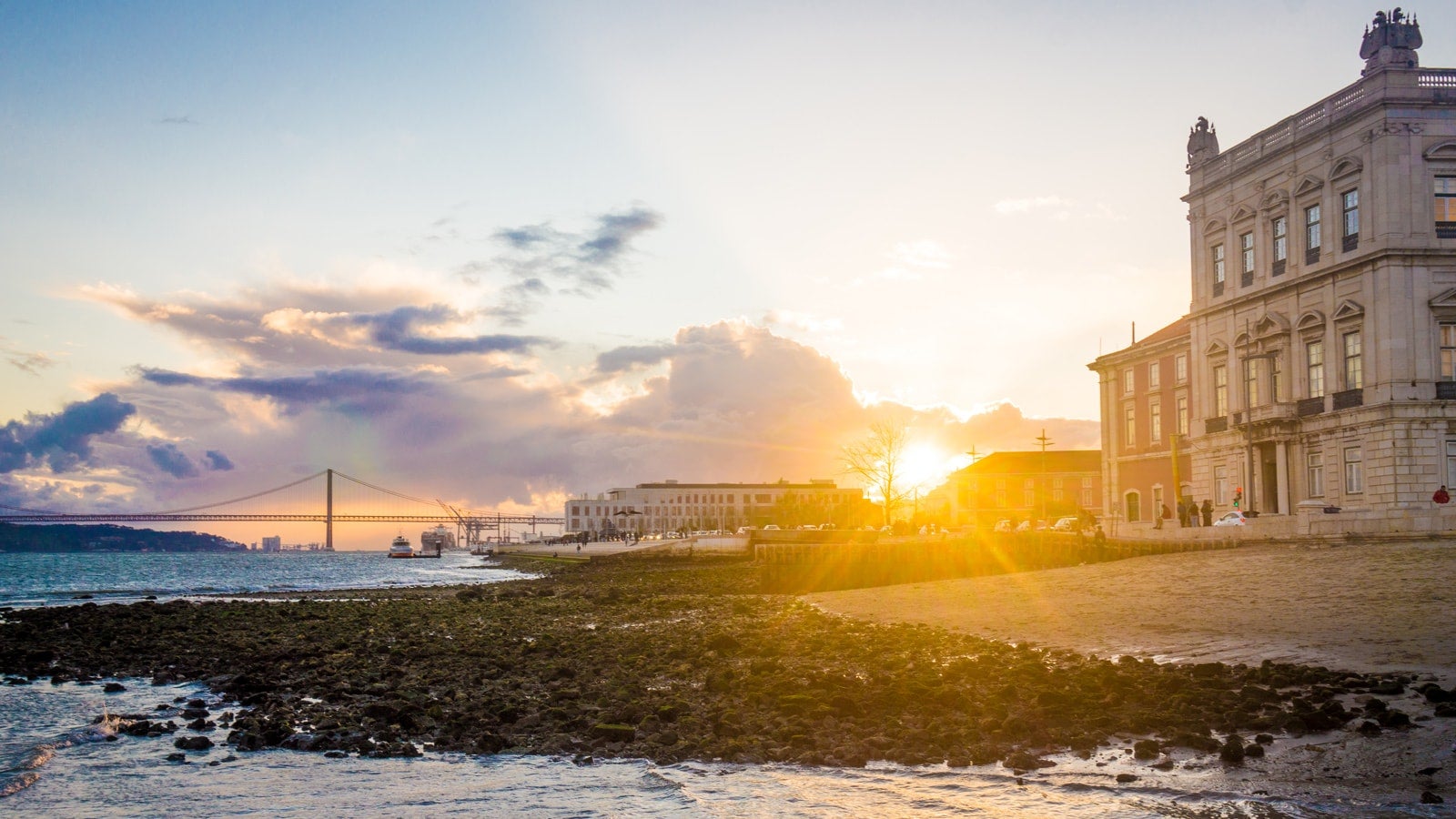 A photo of Lisbon Wharf with the sun setting in the background