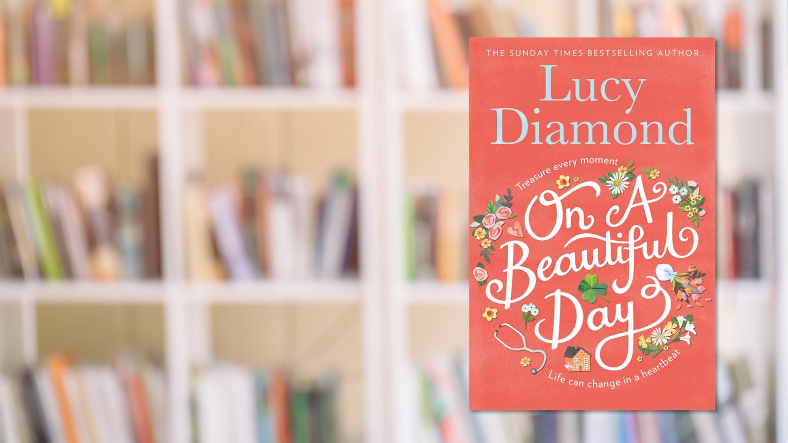 Lucy Diamond's On A Beautiful Day against a backdrop of a bookshelf.