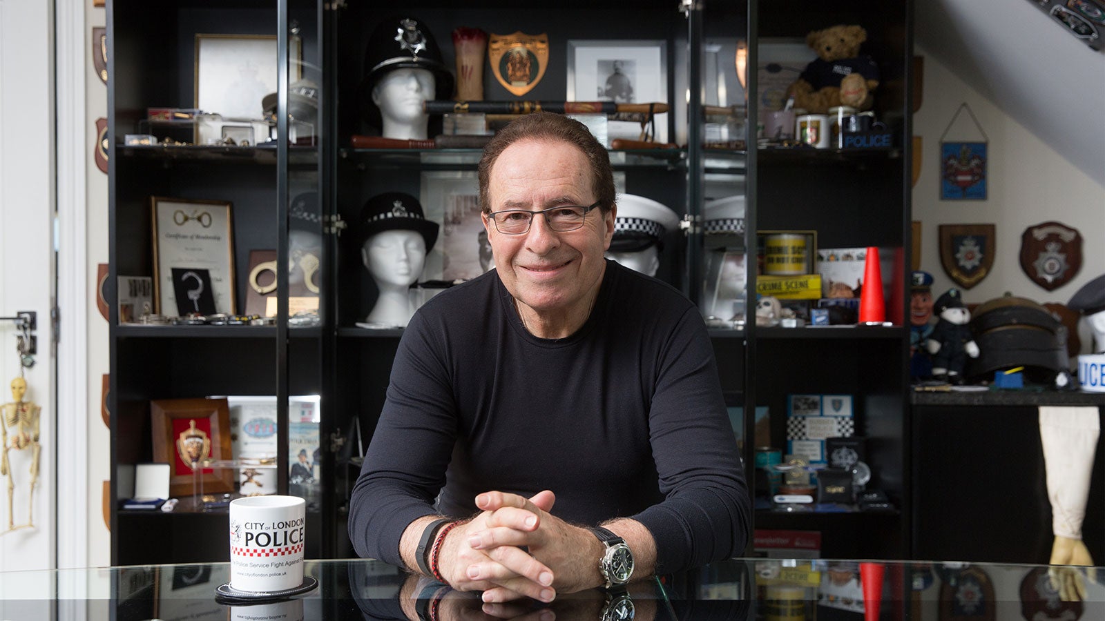 Peter James sat at a table surrounded by police memorabilia. 