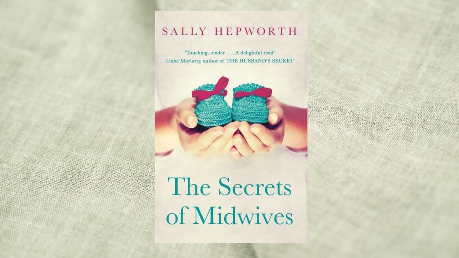 Book cover for The Secrets of Midwives with a fabric background 