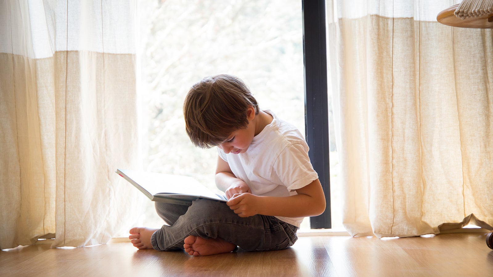 Small boy reading a book.