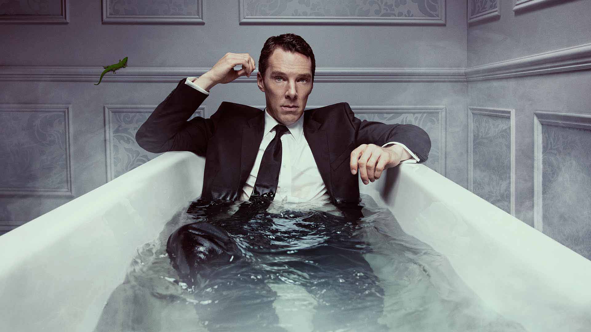 Benedict Cumberbatch as Patrick Melrose in a suit in a bath