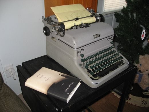 An old grey typewriter, with Kent's book Our Souls at Night sitting to the left of it