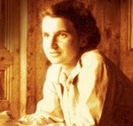 Sepia toned photograph head and shoulders of a smiling Rosalind Franklin 
