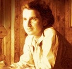 Sepia toned photograph head and shoulders of a smiling Rosalind Franklin