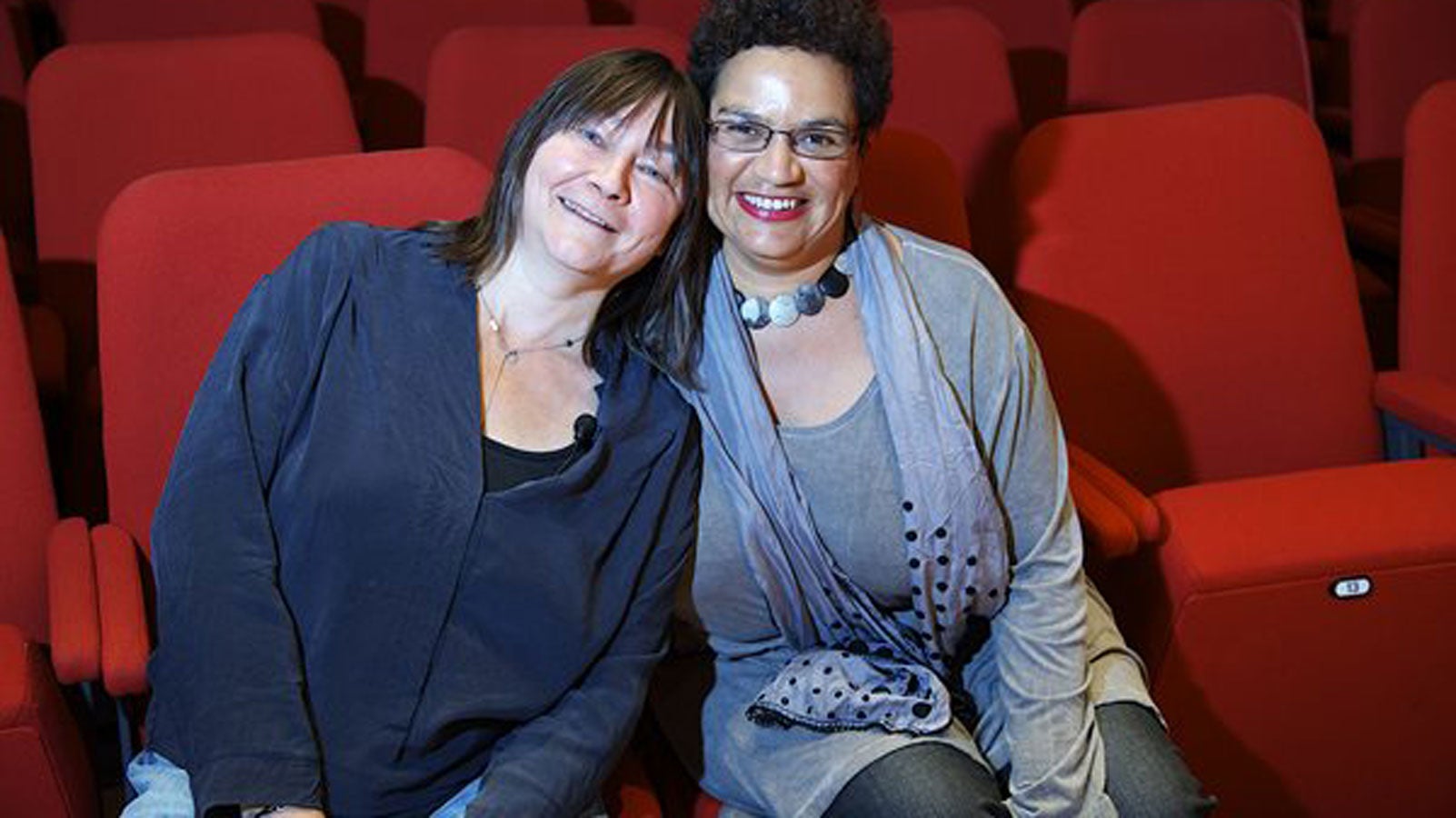 Ali Smith and Jackie Kay sitting next to eachother smiling 
