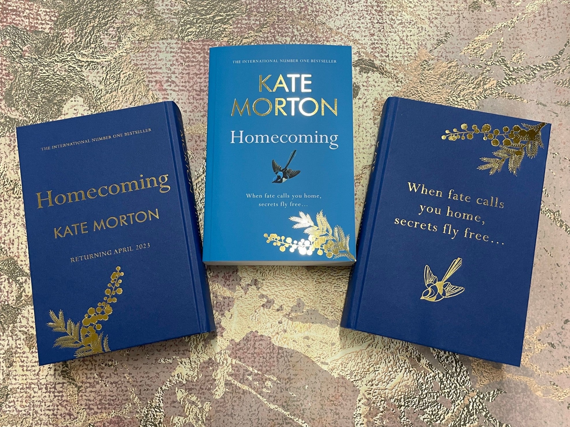 Two hardback proofs of Homecoming by Kate Morton beside a paperback proof.