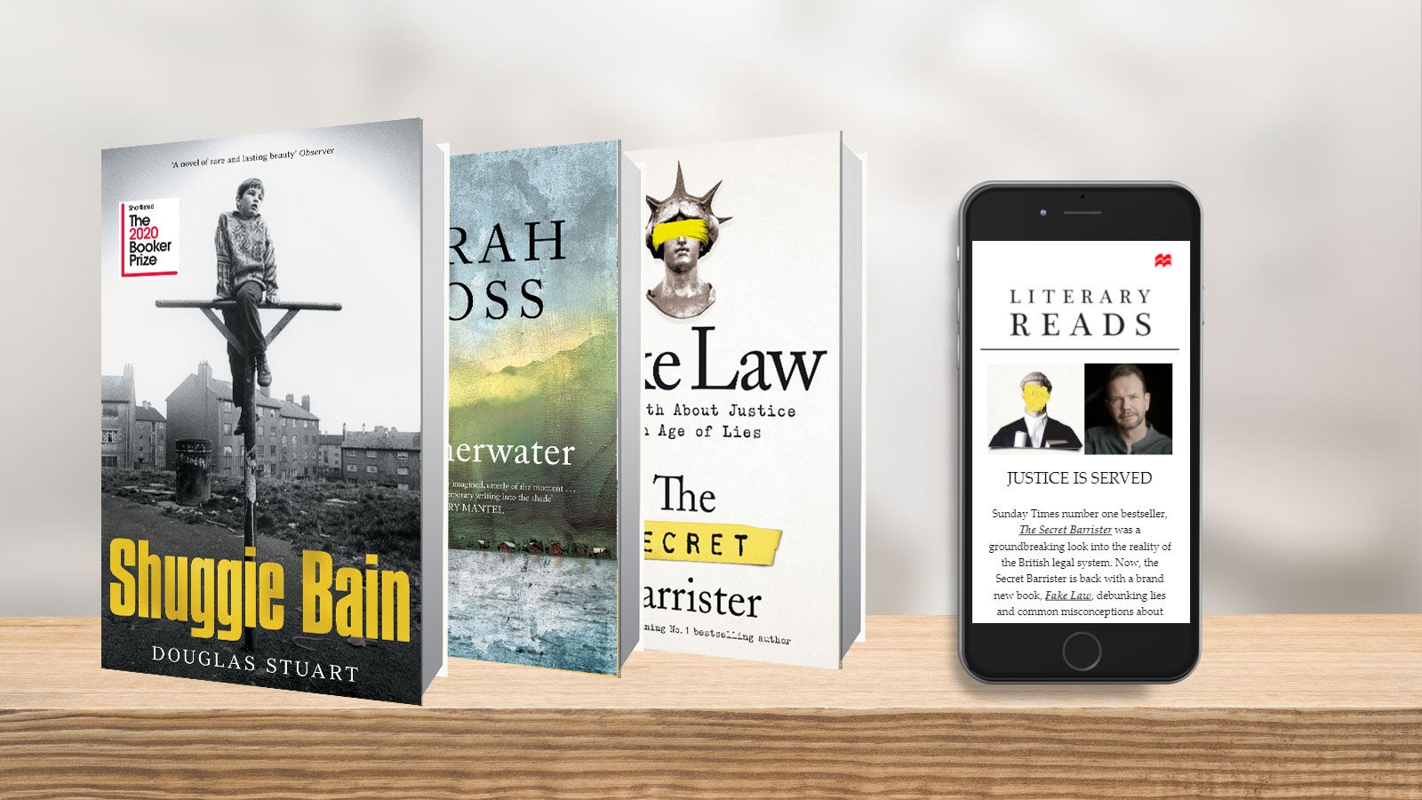 Shuggie Bain, Summerwater and Fake Law beside an iPhone displaying the Literary Reads newsletter.