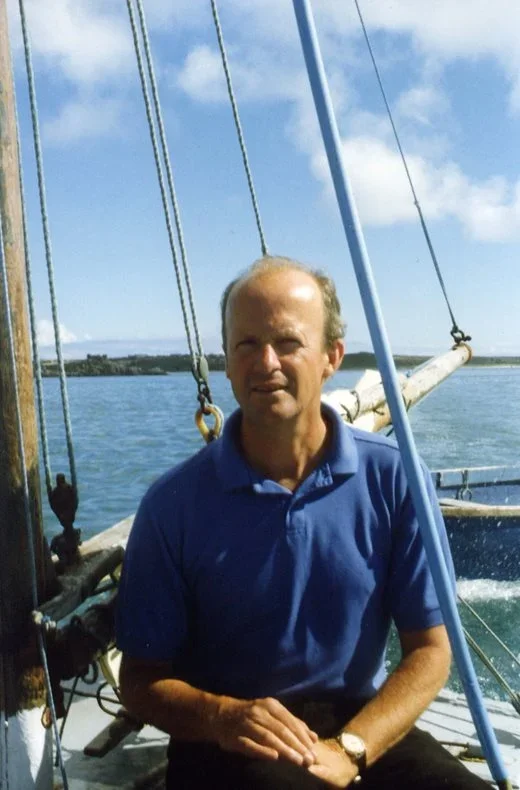 Jim Crace on a boat in the Scilly Isles
