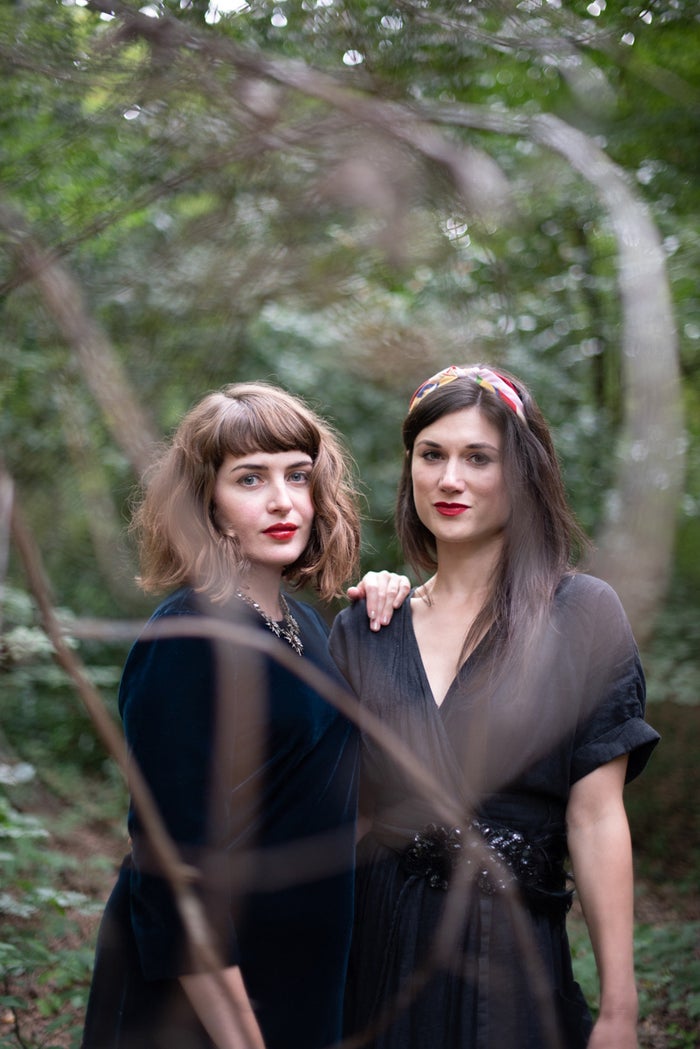 Jen Cownie and Fiona Lensvelt smiling to camera standing in woodland