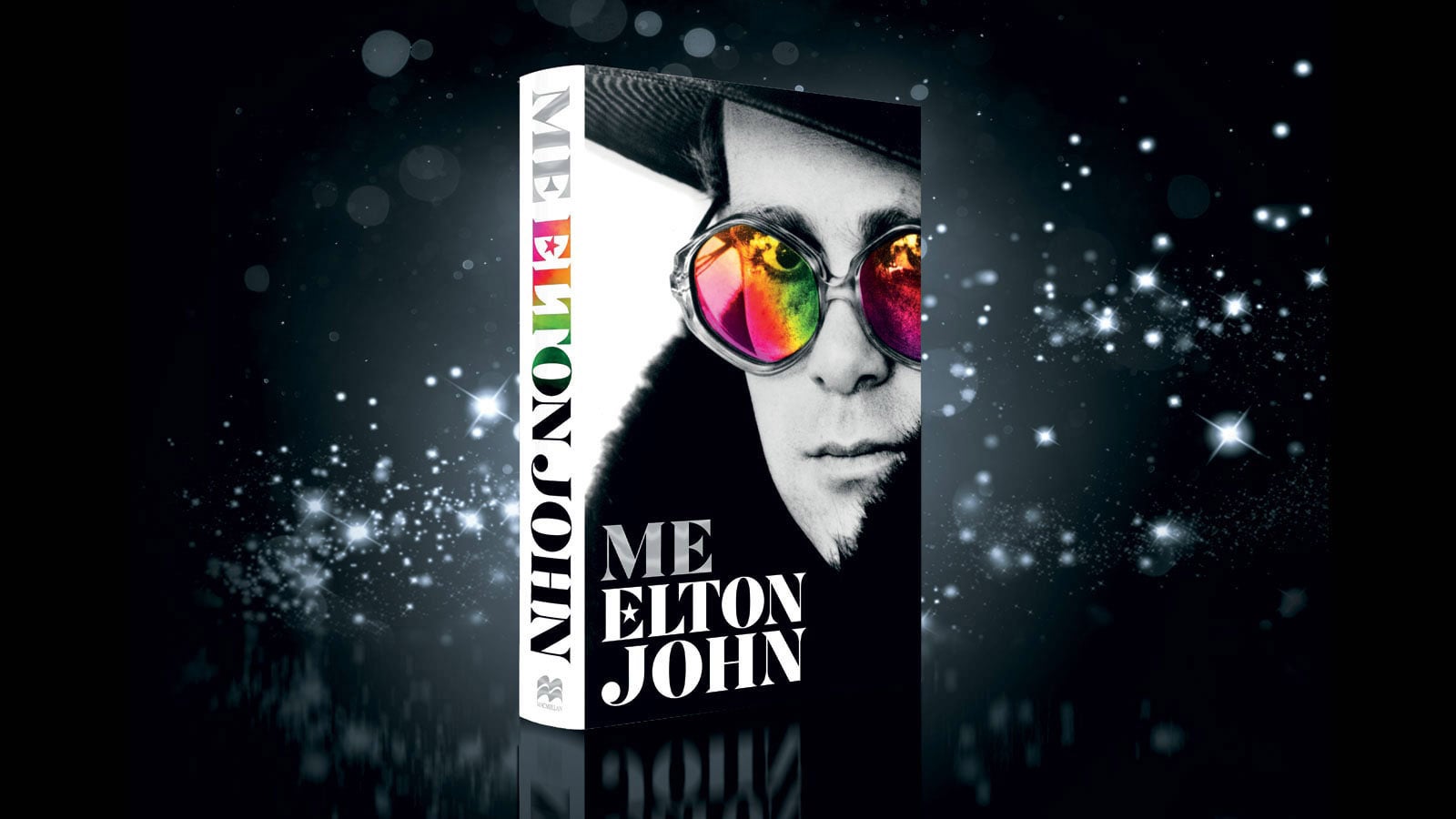The cover of Me, set against a black background with silver sparkles around it