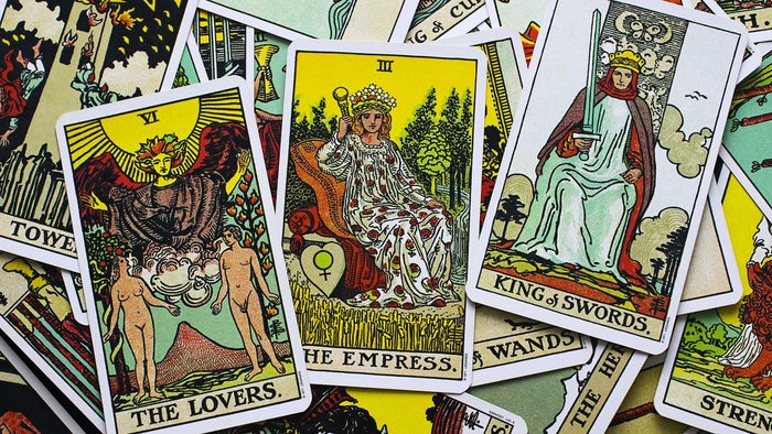 An array of tarot cards laid out, with The Lovers, The Empress and King of Swords cards all clearly visible