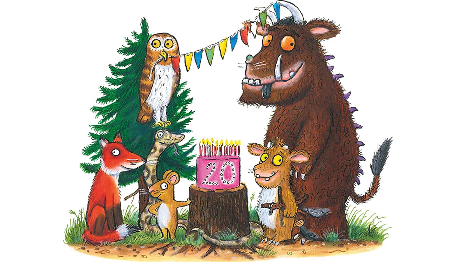 The Gruffalo, The Gruffalo's Child, the mouse, fox, snake and owl in the woods, standing smiling around a birthday cake with bunting above them