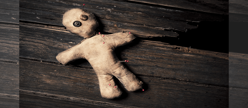 Voodoo doll on wooden floor