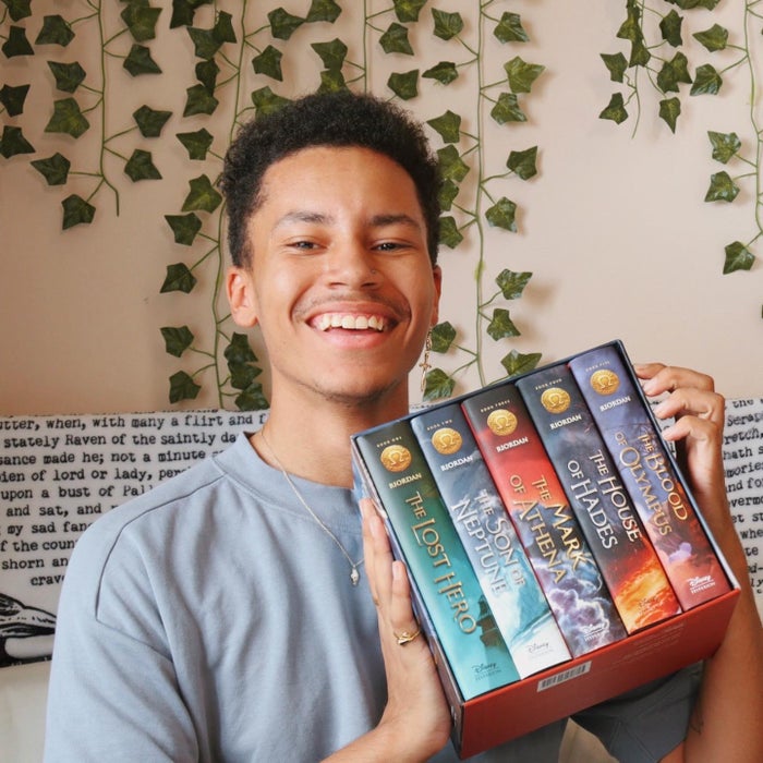 Picture of Joel holding up a stack of books