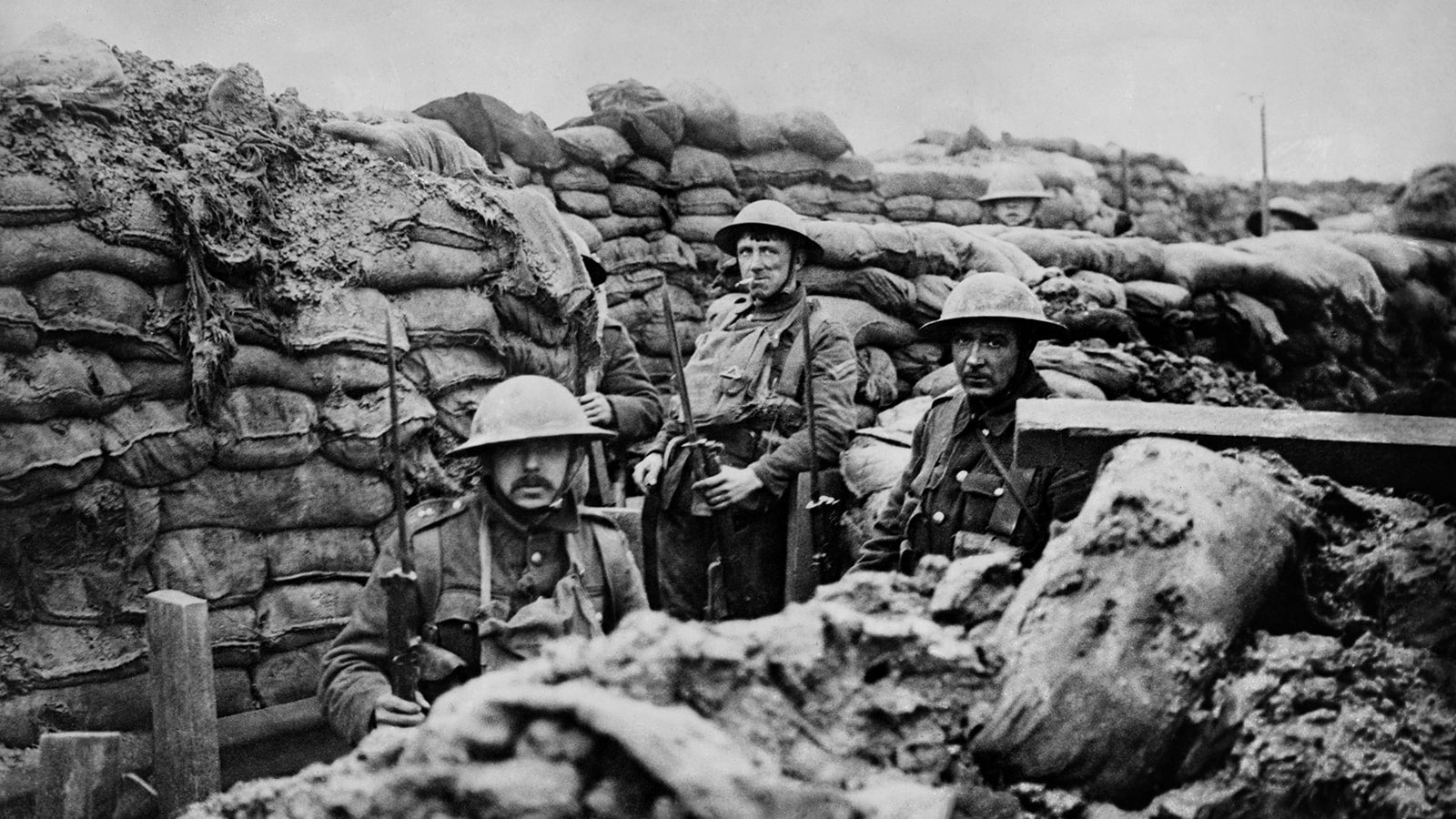Black and white photograph of 3 WW1 soldiers in a trench