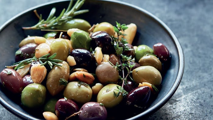 Warm Herbed Olives with Marcona Almonds in a bowl