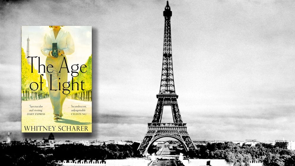 The Age of Light cover against a black and white photo of the Eiffel Tower
