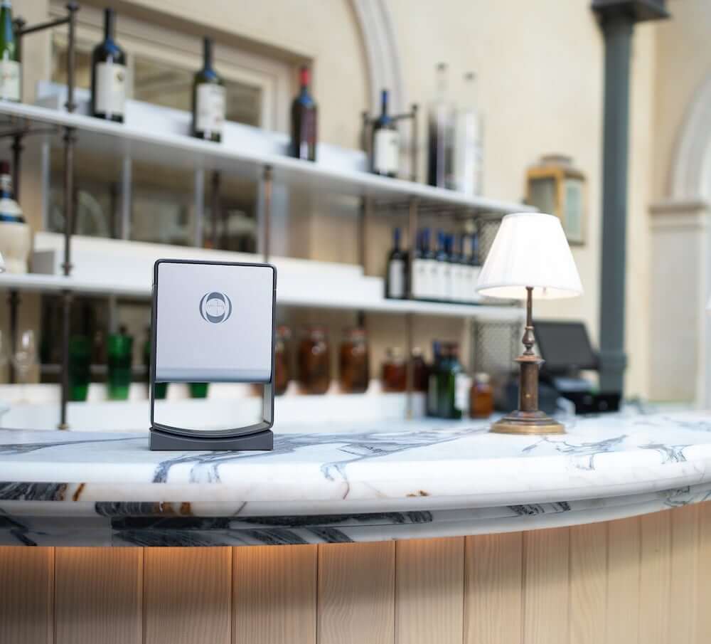 Grey INEOS Dispenser sat on white marble countertop
