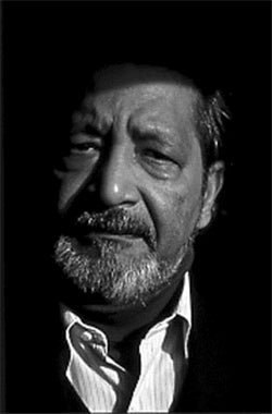 A black and white headshot of Sir V.S Naipaul