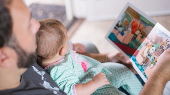 Image of male reading to a girl child