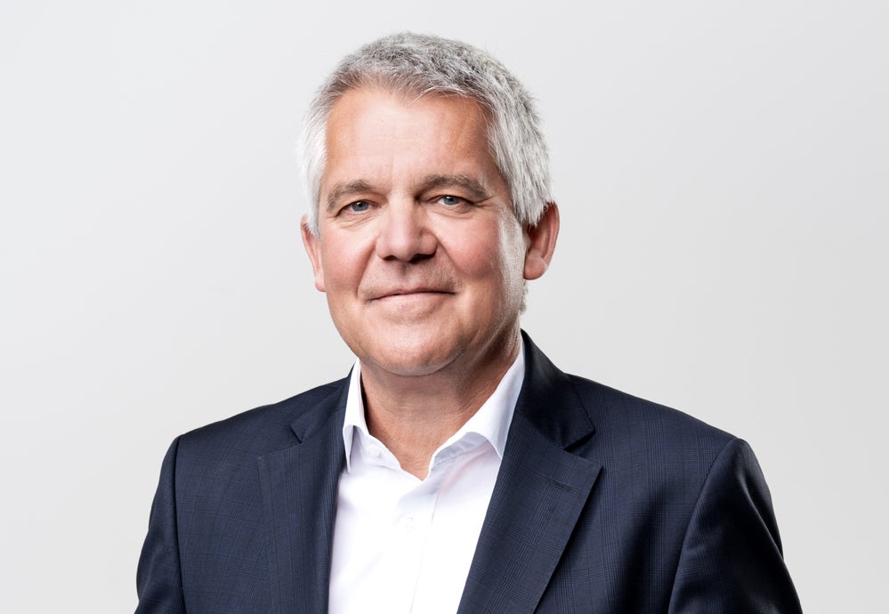 Professor Peter Bader, Chief Operating Officer and Managing Director of the new DKMS Access To Treatment gGmbH, wearing a dark blue suit jacket and a white shirt, looks directly at the camera with a gentle smile. Professor Peter Bader, Chief Operating Officer and Managing Director of the new DKMS Access To Treatment gGmbH, wearing a dark blue suit jacket and a white shirt, looks directly at the camera with a gentle smile.