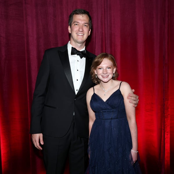 The DKMS donor William Dossett, wearing a black tuxedo, stands beside the 13-year-old acute myeloid leukemia survivor Madison Adams, wearing a navy blue gown. They are both smiling in front of a red curtain backdrop at the DKMS New York Gala 2025. The DKMS donor William Dossett, wearing a black tuxedo, stands beside the 13-year-old acute myeloid leukemia survivor Madison Adams, wearing a navy blue gown. They are both smiling in front of a red curtain backdrop at the DKMS New York Gala 2025.